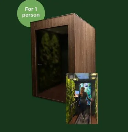 Nature Station COMFY — wooden office pod for one person, with an interior view of a person walking during a video call